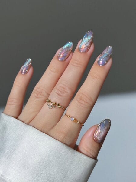 Iridescent almond nails inspired by butterfly wings with a shimmering finish.