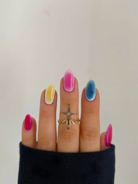 Multicolour Aura Nails With Mixed Colour Pop — short oval nails with individual pink, yellow and blue aura effects fading to white edges