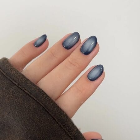 Slate Blue Aura Nails — short oval nails with deep slate blue grey aura fading to a transparent sheer edge
