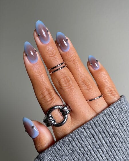 Periwinkle Blue Aura Nails With Silver Bead Details — long almond nails with soft periwinkle blue aura fading to sheer edges with a silver ball charm at each cuticle