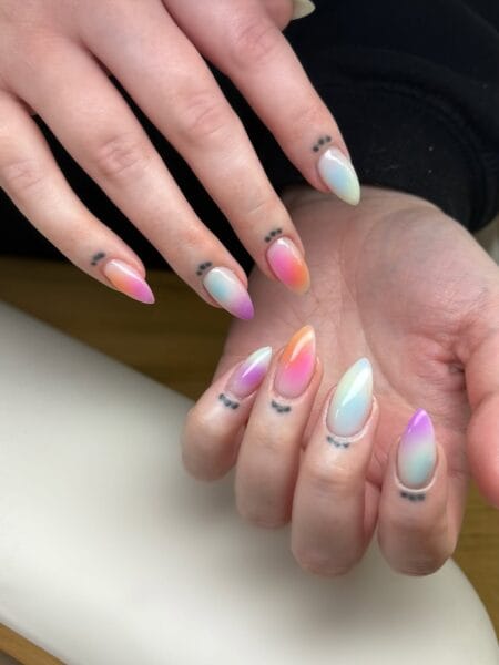 Pastel Rainbow Aura Nails — long almond nails with individual pastel aura blends in lilac, mint, coral, peach and baby pink over a white base