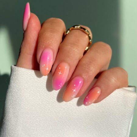 Pink to Peach Aura Nails With Star Details — long almond nails with hot pink to coral peach aura gradient and white star sparkle details