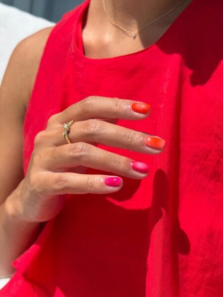 Coral to Hot Pink Mixed Aura Nails — short square nails with individual coral orange and fuchsia pink aura effects fading to bare skin