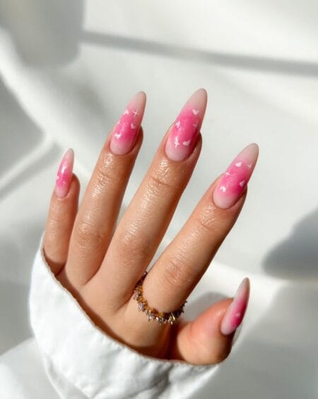 Baby Pink Aura Nails With Hearts and Stars — long almond nails with nude to rose pink aura gradient scattered with white hearts and star details