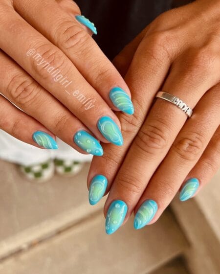 Aqua Blue and Lime Green Swirl Aura Nails — long almond nails with vivid turquoise aura base and swirling lime green shapes with pearl dot details