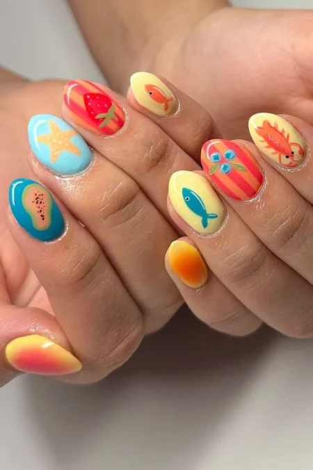 Short oval nails in full tropical beach scene with starfish, strawberry, orange fish, teal fish, papaya and sunset gradient nails — tropical beach scene fish nails 2026