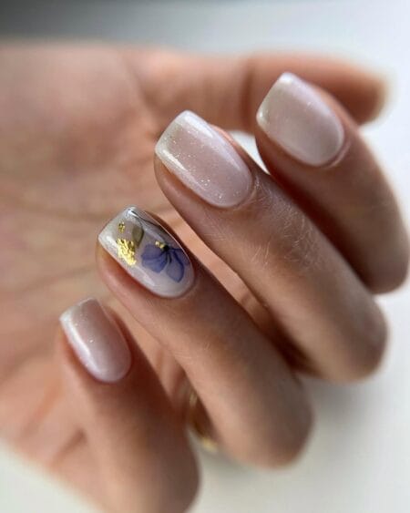 Pearl shimmer short square nails with pressed blue flower and gold foil accent nail