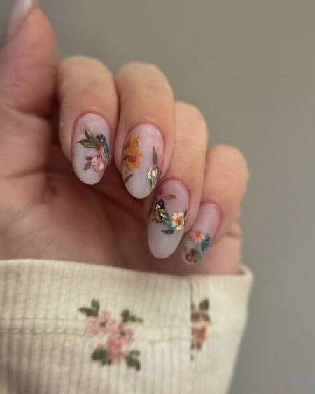 Botanical garden painting nails with hummingbirds and wildflowers on sheer lavender almond nails