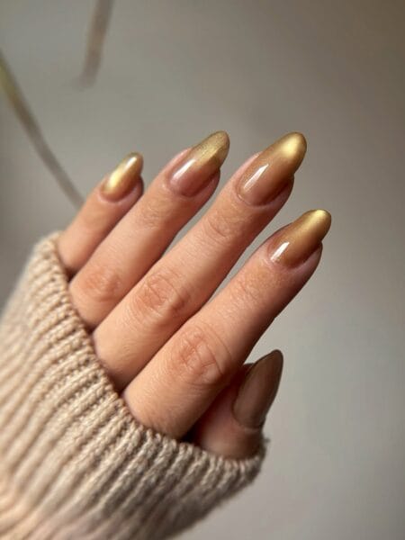 Burnished gold chrome almond nails with molten antique bronze to gold gradient finish