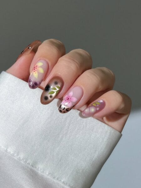 Leopard print and pink lily garden nails on frosted nude base with earthy floral mix