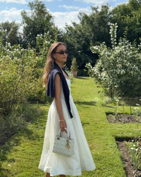 White full-skirt midi dress with navy shoulder cardigan modest summer outfit