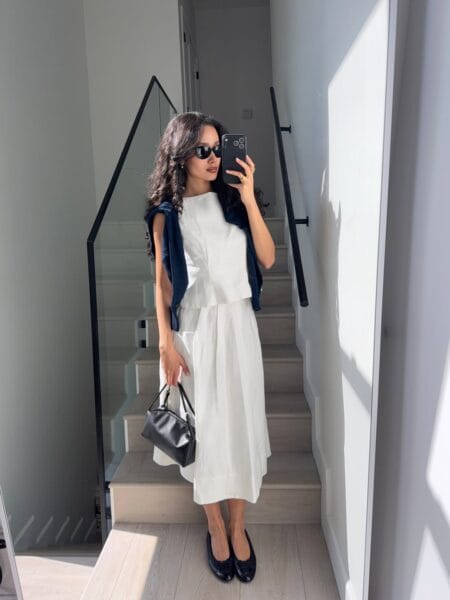 White structured top with white midi skirt and navy cardigan modest summer outfit