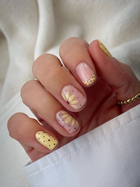 Butter yellow sunflower polka dot nails on short square nails with burgundy dot accents