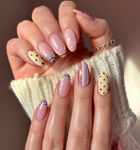 Retro stripe and polka dot mixed nail set with butter yellow dot nails and multicolour stripe accent on almond shape