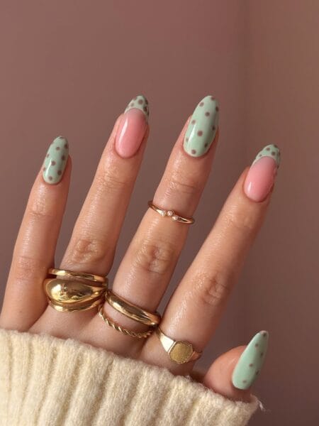 Mint green and pink pastel polka dot nails with rose-brown dots alternating with clean pink almond nails