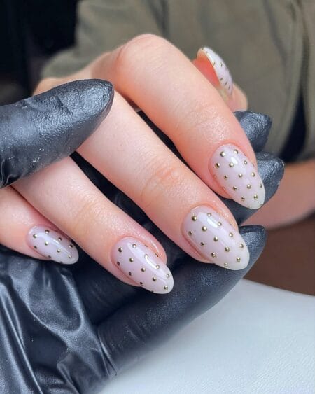 Nude and gold micro stud polka dot nails in grid pattern on lilac-nude almond base