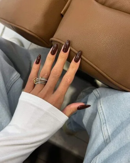 Glossy espresso brown almond nails with a rich coffee-inspired finish.