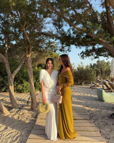 White Grecian gown and mustard off-shoulder gown, autumn wedding guest dresses
