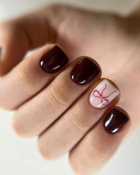 Dark chocolate maroon nails with ribbon bow accent