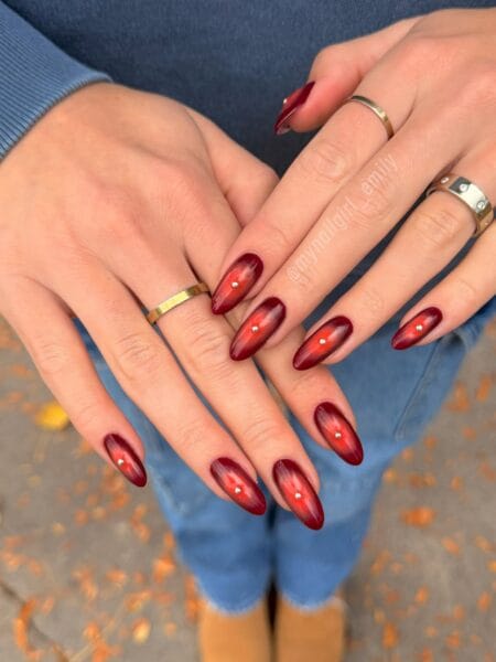 Deep red cat eye maroon nails with crystal centres
