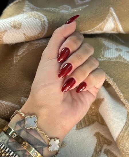 Deep cherry maroon almond nails with glass gloss finish