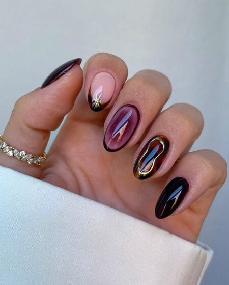 Mixed maroon and tortoiseshell skittle nails