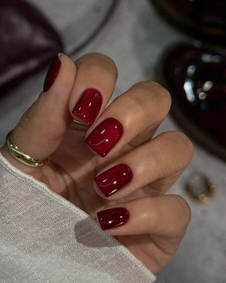 Deep red shimmer nails on short square shape