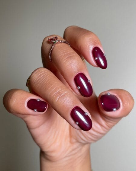 Maroon jelly nails with pearl stud accents