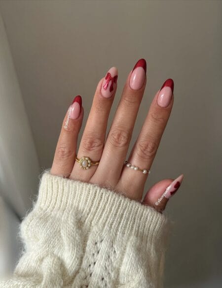 Red French maroon nails with bow and pearl accents