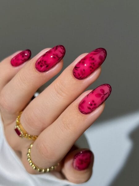 Berry maroon jelly nails with dark floral design