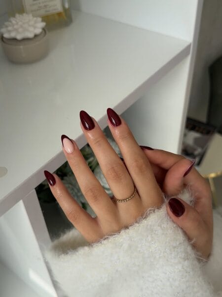 Glossy maroon almond nails with nude accent for fall