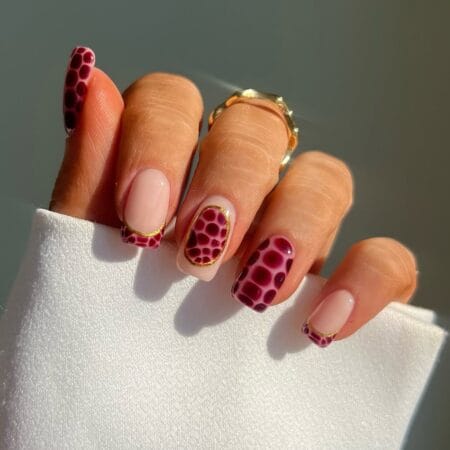 Maroon croc print nails with gold outlines