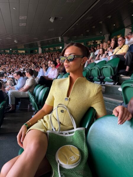 Yellow tweed mini dress with tennis ball handbag for a playful Wimbledon outfit.