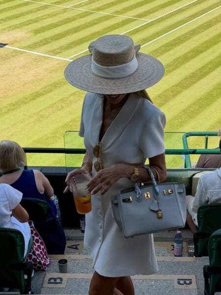 Ivory shirt dress with wide-brim boater hat for a classic Wimbledon look.