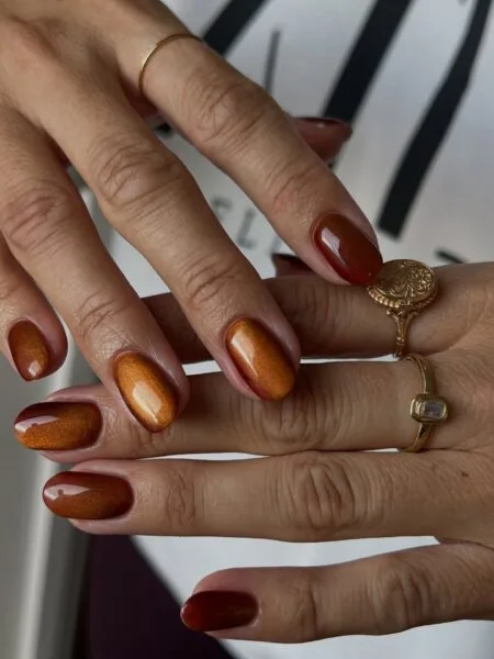 Copper metallic nails with a reflective chrome finish.