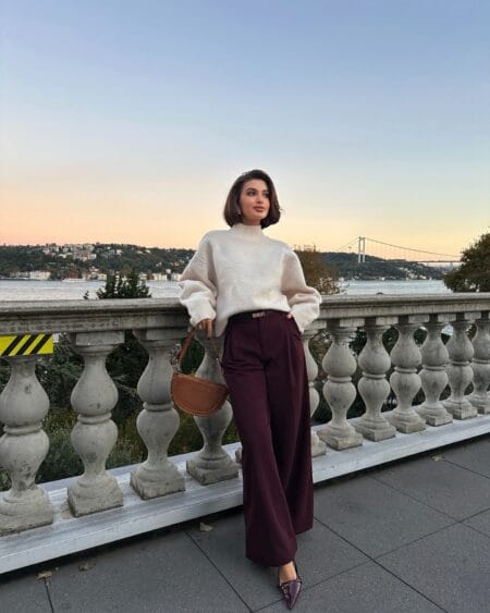 Cream knit tucked into burgundy wide-leg trousers, a wine coloured fall outfit