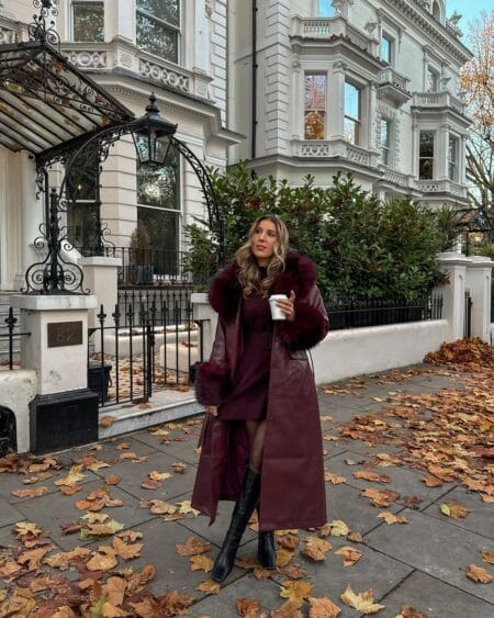 Floor-length burgundy leather coat with fur trim over a wine knit dress, a burgundy autumn outfit