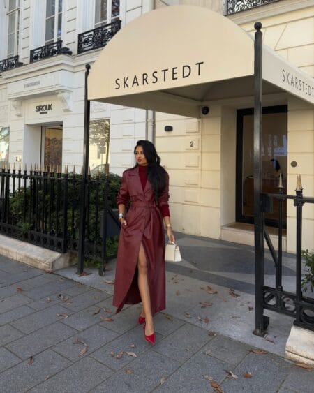 Belted burgundy leather trench with a red turtleneck and red heels, a monochrome burgundy fall outfit