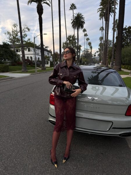Oxblood patent shirt jacket with a burgundy lace pencil skirt, a burgundy fall outfit for evening
