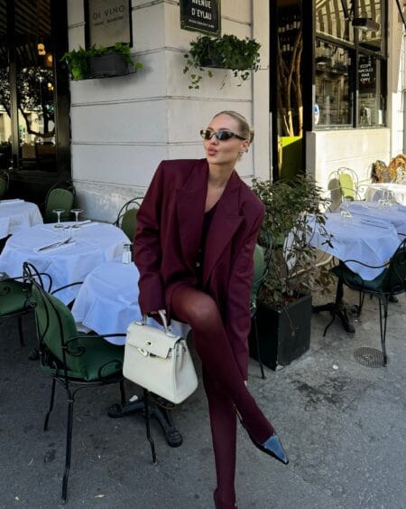 Oversized burgundy blazer with matching tights and black heels, a tonal burgundy autumn outfit