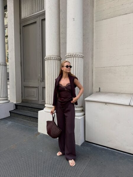 Burgundy satin lace cami with matching trousers and a knit waistcoat, a transitional burgundy fall outfit
