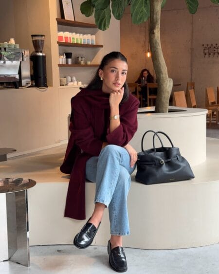 Burgundy knit with a draped scarf and light-wash denim, a casual burgundy autumn outfit