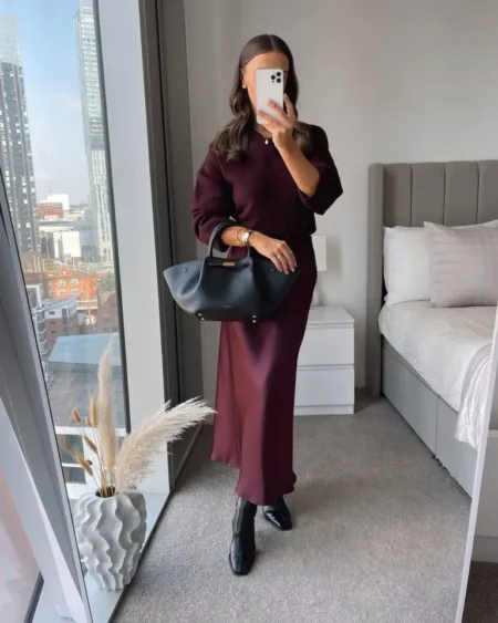 Burgundy knit top with a satin midi skirt and ankle boots, a wine coloured fall outfit