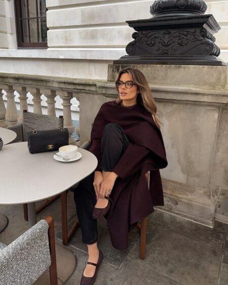Aubergine scarf coat with black denim and suede flats, a casual burgundy autumn outfit