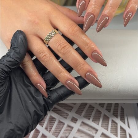 Warm taupe stiletto nails with glossy finish