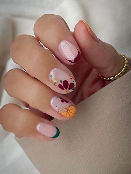 Folk floral fall nails with gold pumpkin accent
