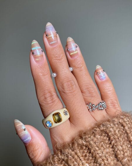 Iridescent lilac and peach aura almond nails with silver studs