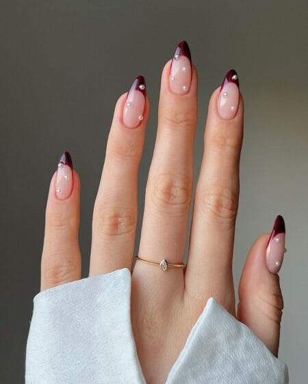 Burgundy French tip almond nails with white micro-pearls