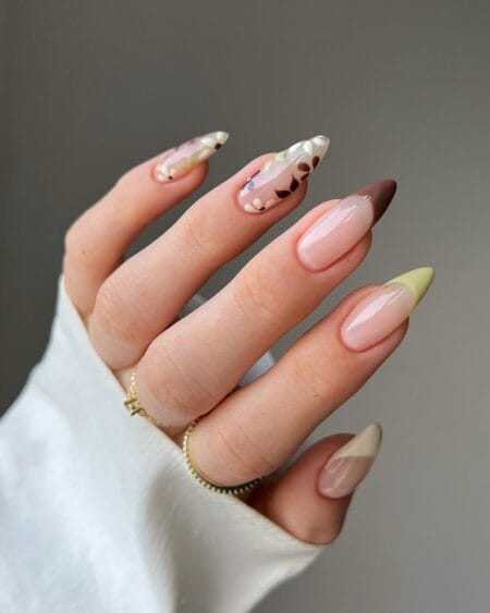 Neutral floral almond nails with butter yellow and chocolate French tips