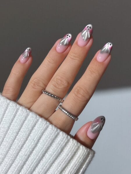 Soft pink nails with silver chrome ghosts halloween nails